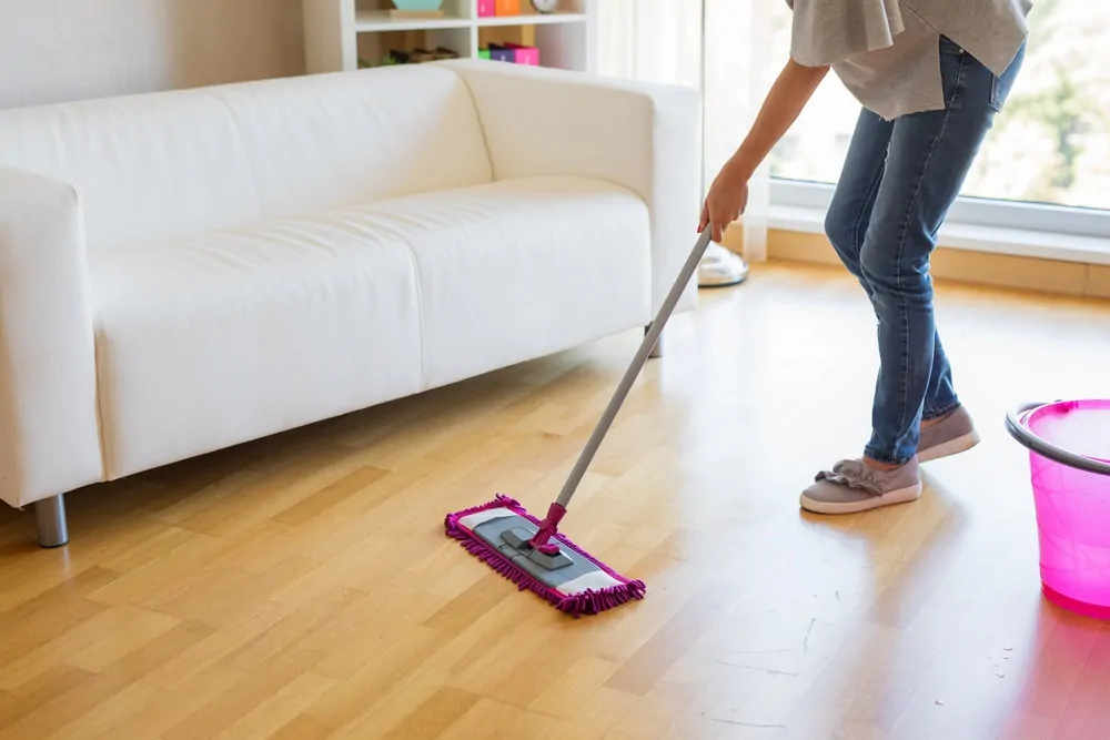 Woman mopping living room floor