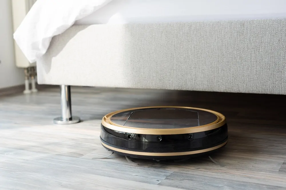 Robot mop cleaning the floor under a bed