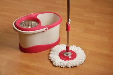 a red and white spin mop and bucket