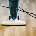 Corded stick vacuum on laminate floor