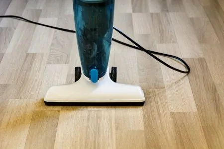 Corded stick vacuum on laminate floor
