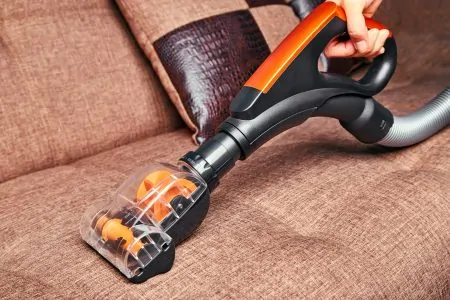 Cleaning sofa with a handheld vacuum