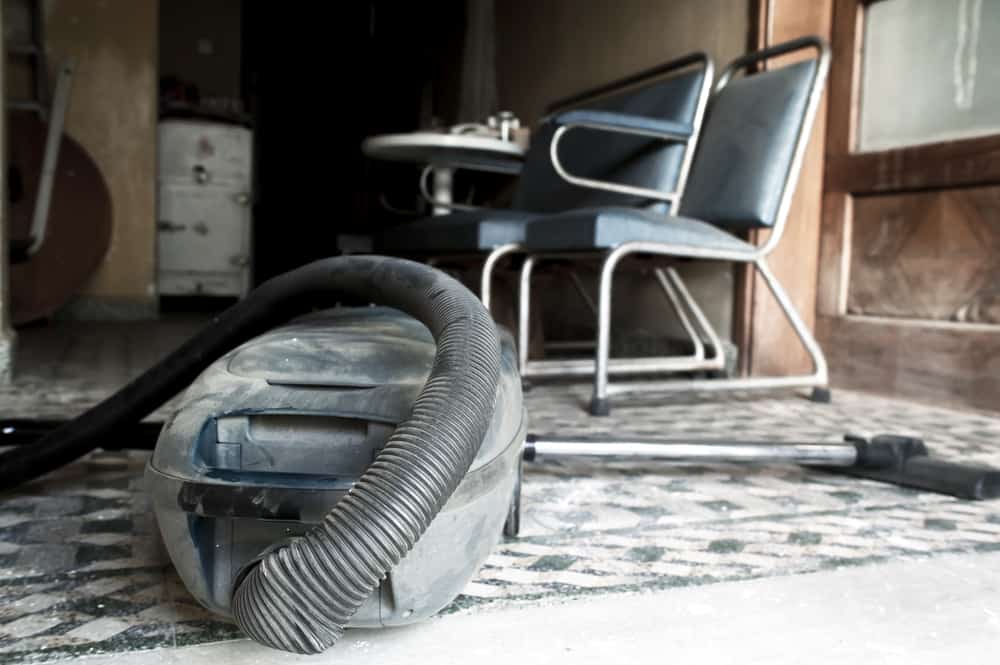 Old vacuum cleaner in a dusty house