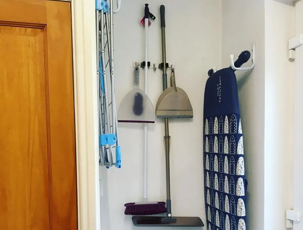 Keeping broom and mop on a wall hanger