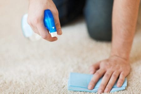 Man cleaning carpets with best carpet cleaning shampoo