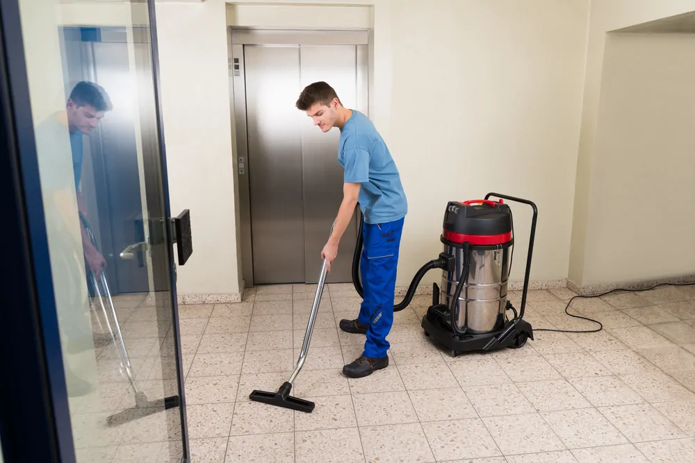 Vacuuming tile floor with a shop vacuum