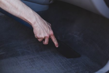 Man cleaning car carpets