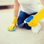 Woman cleaning smelly carpet
