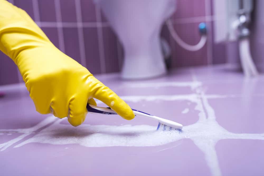 Cleaning tile grout using toothbrush
