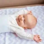 Baby sleeping in nursery with air purifier