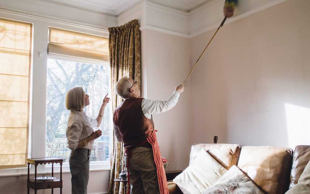 Husband and wife dusting the ceiling