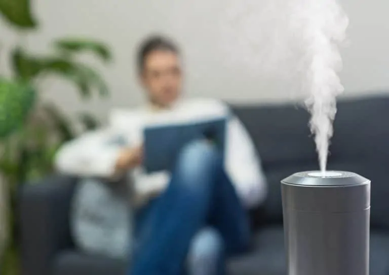 Man reading in the living room with a humidifier