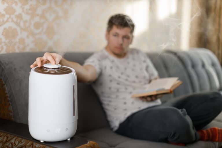Man using a personal humidifier