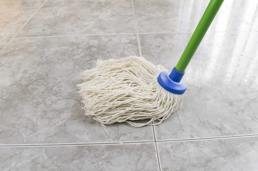 String mop being used to clean floor