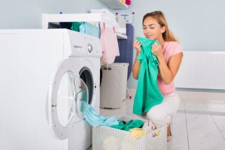 Woman smelling freshly washed laundry