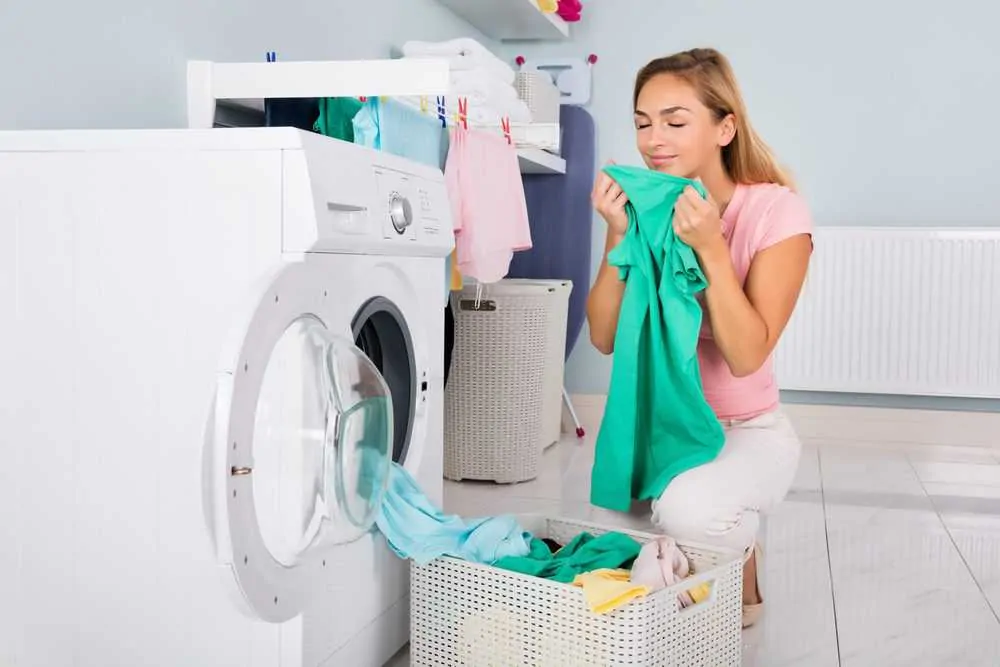 Woman smelling freshly washed laundry