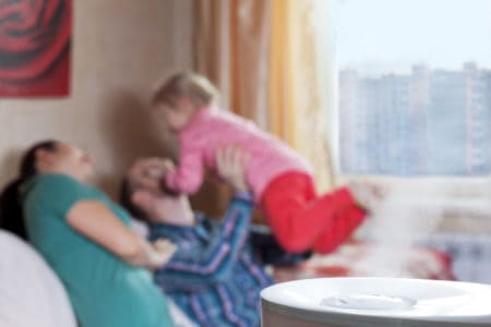 Happy family running a humidifier at home