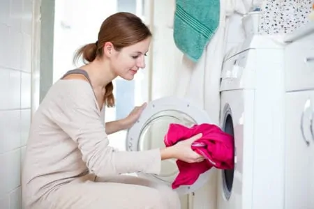 Woman machine washing polyester