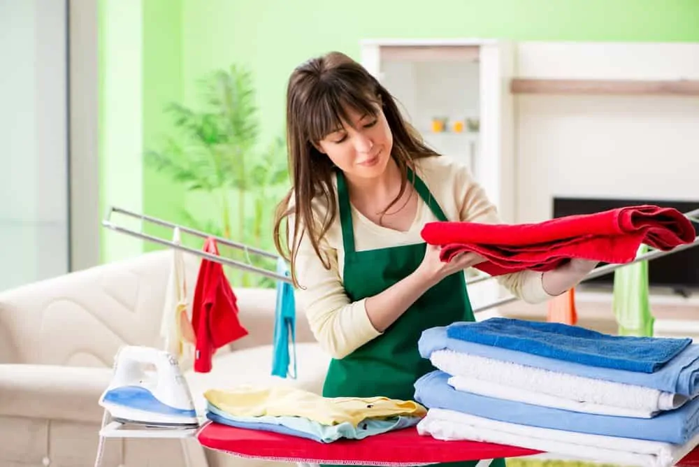 Woman ironing fresh laundry