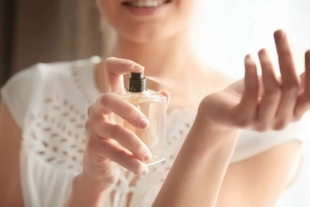 Woman spraying fragrance