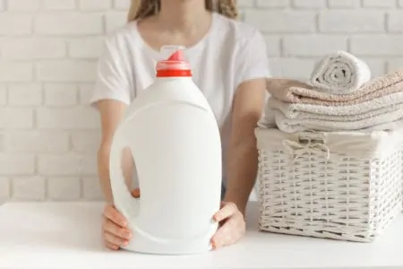 Woman holding a bottle of laundry softener