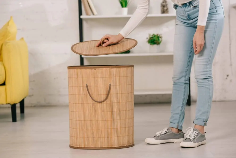 Woman opening her laundry hamper