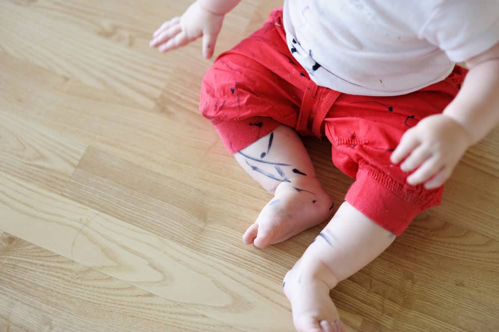 Toddler with spilled ink on his clothes