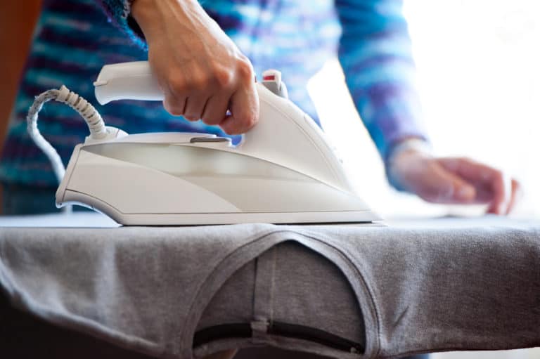 Woman ironing polyester shirt