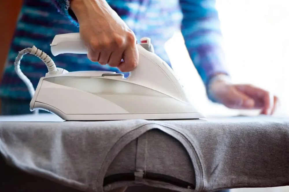 Woman ironing polyester shirt