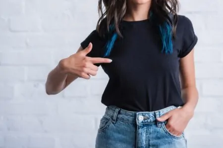 Woman pointing to her shirt without print