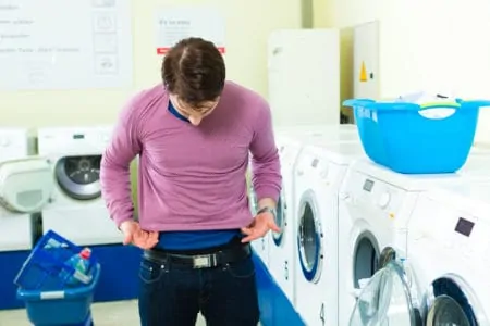 Man wearing shrunken shirt after doing laundry
