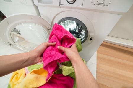 Woman machine washing towels