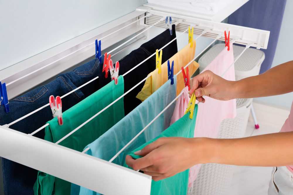 Woman hanging clothes to dry on the rack