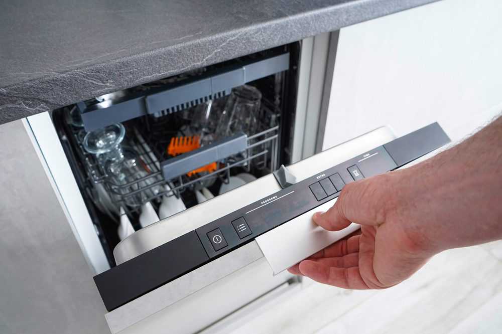 Man opening a panel ready dishwasher