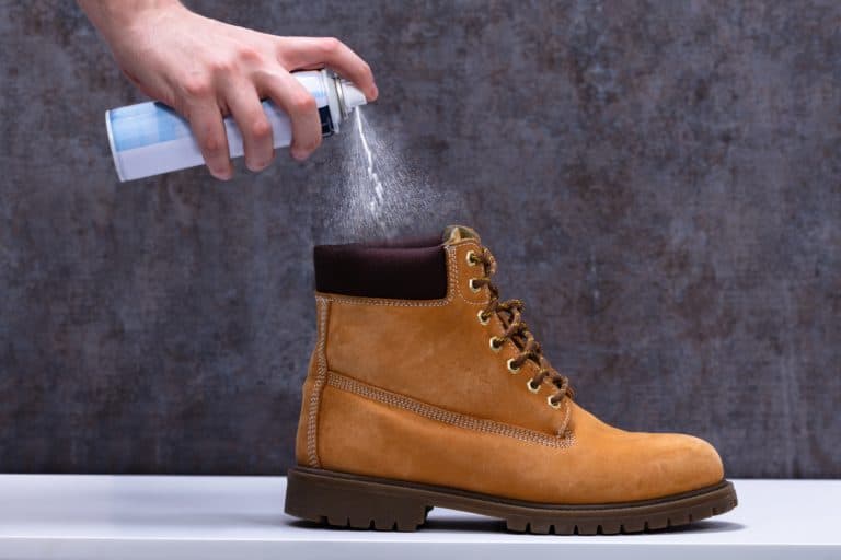 Spraying anti-odor spray to leather boots