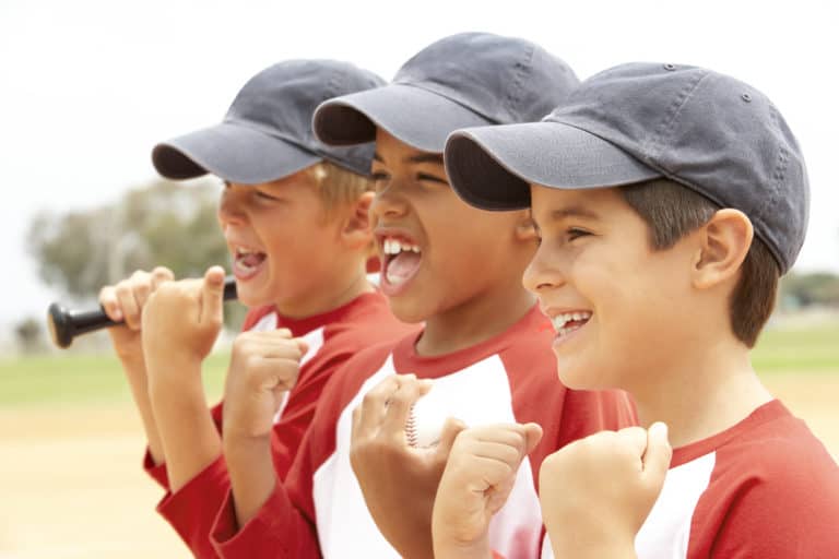 Young boys wearing baseball caps