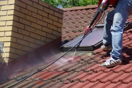 House roof cleaning with pressure washer