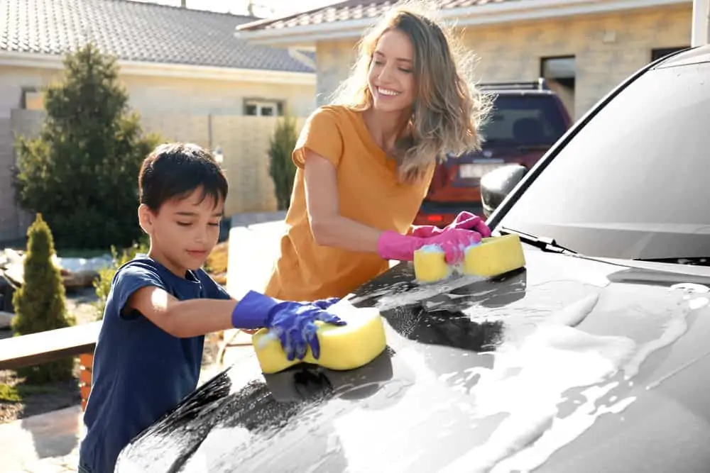 Mother and son washing car