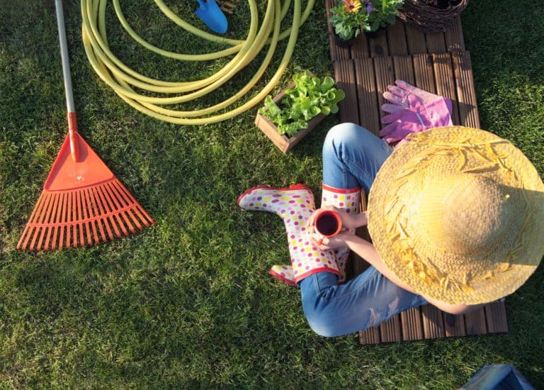 Woman taking a break from lawn maintenance