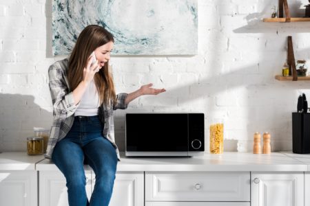 Woman planning to dispose old microwave