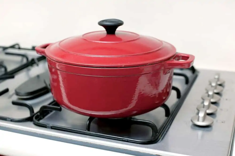 Red ceramic pot on top of stove