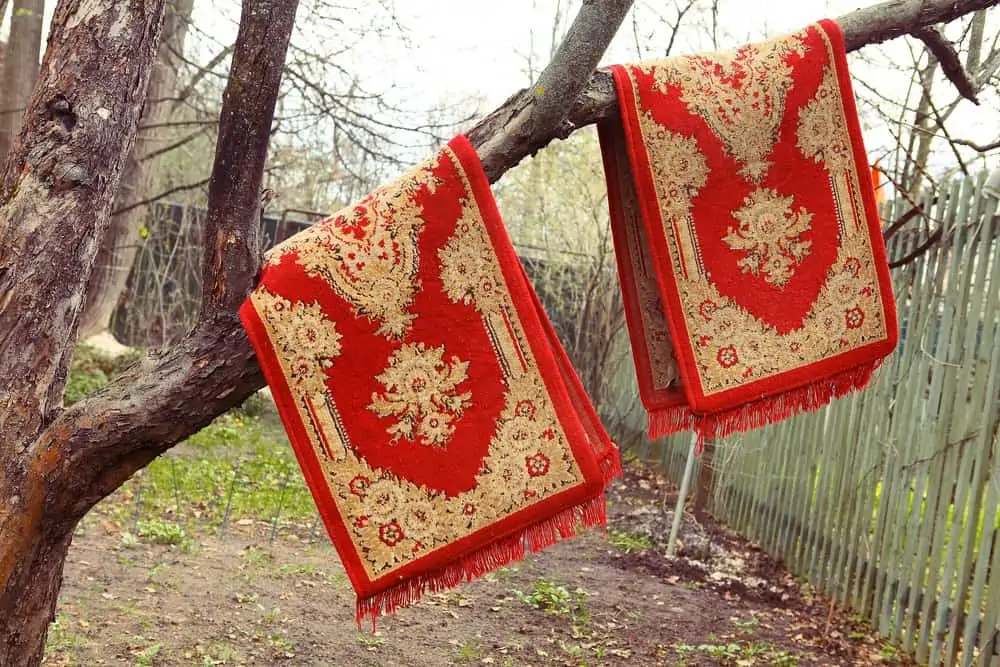 Red Persian rugs hanging on the tree