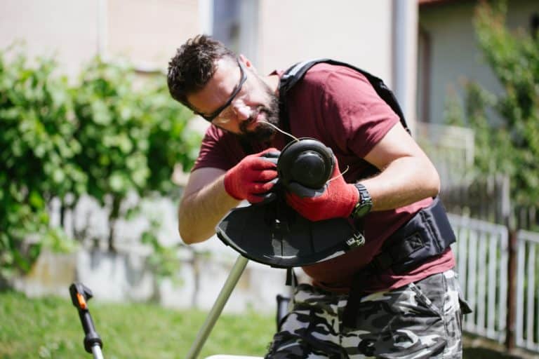 Man holding a string trimmer