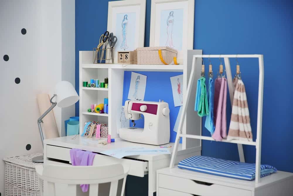 Craft room storage desk with sewing machine and different sewing supplies