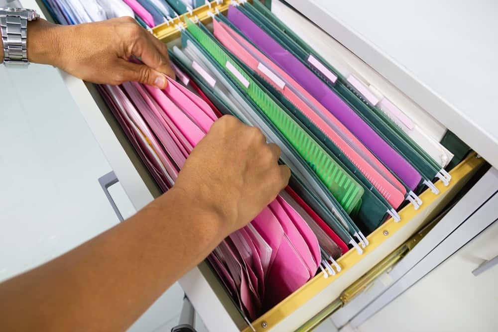 Man searching files in filing cabinet 
