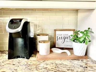 Keurig Coffee Maker on countertop beside creamer and sugar containers