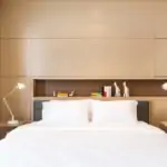 Small bedroom with built-in headboard storage