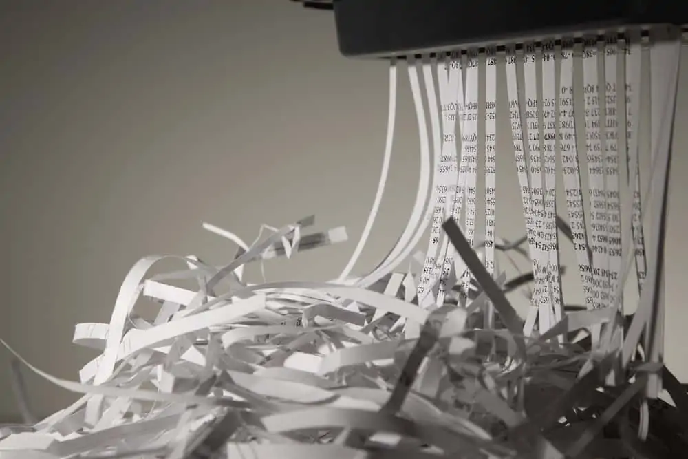 Closeup image of papers being shredded by a paper shredder
