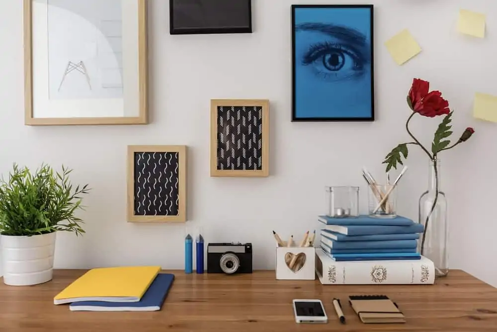 Organized desk with creative frames on the wall