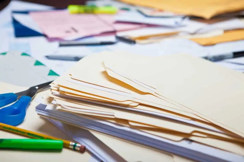 Table full of messy file documents